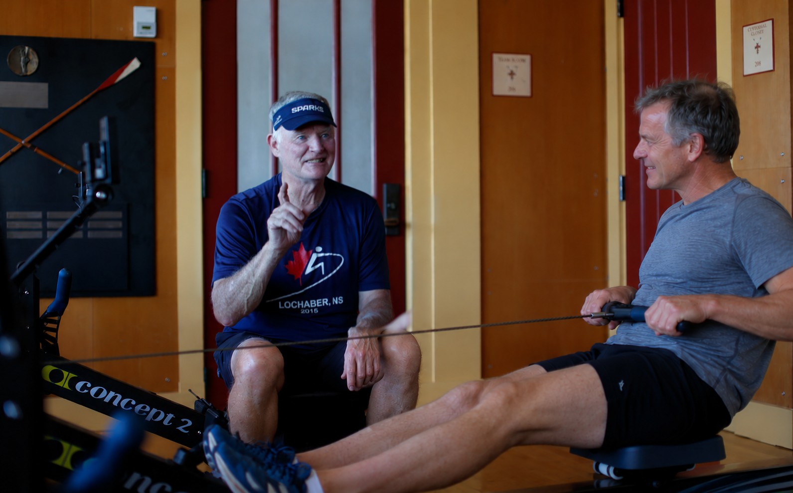 Al Morrow coaching an adult rower on a rowing machine